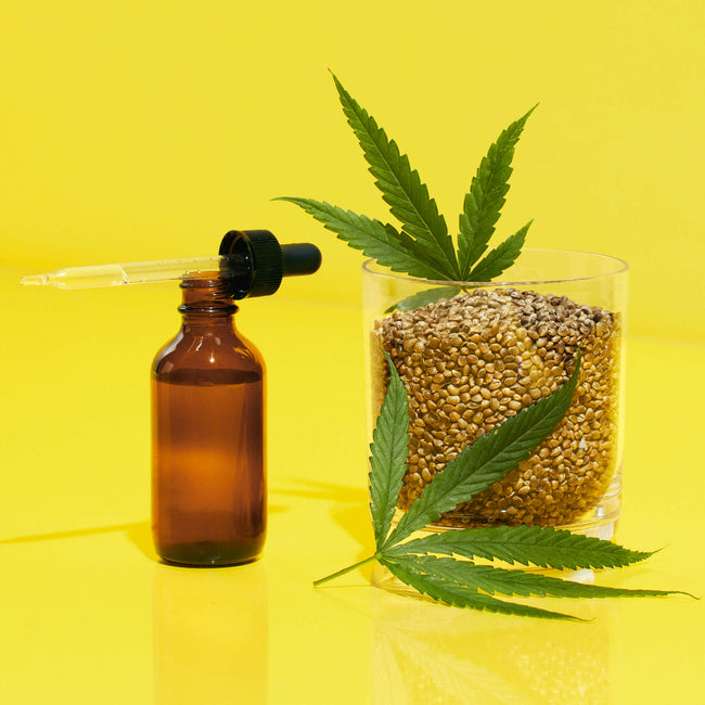 Bottle and dropper with hemp seeds and hemp leaves